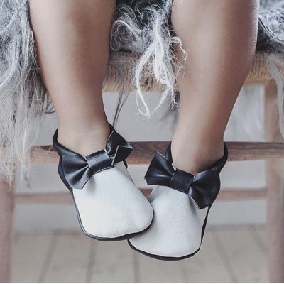 fashionista moccasins on dangling child feet.